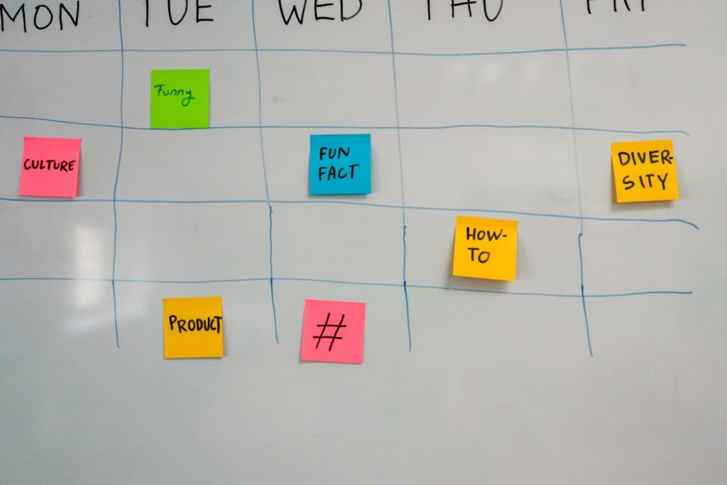 Weekly calendar with colorful sticky notes showing project timeline planning
